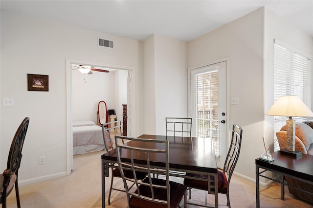 carpeted dining space featuring ceiling fan