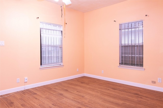 spare room with hardwood / wood-style flooring