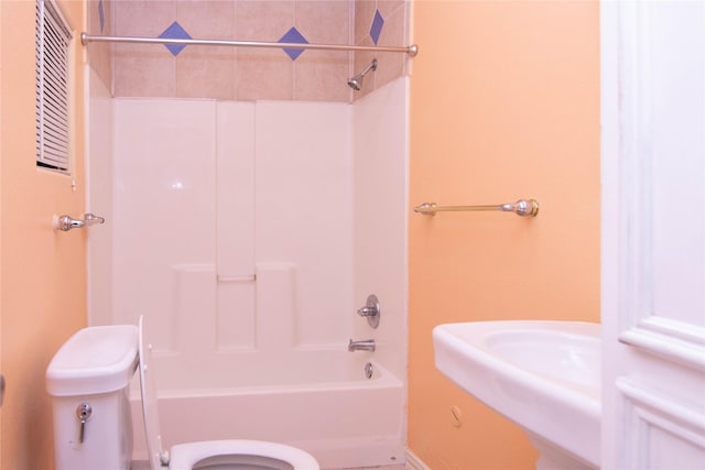 bathroom with shower / washtub combination and toilet