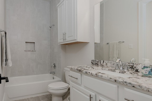 full bathroom featuring vanity, toilet, and tiled shower / bath