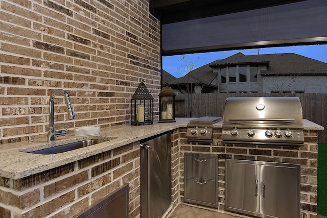 view of patio featuring area for grilling, sink, and exterior kitchen