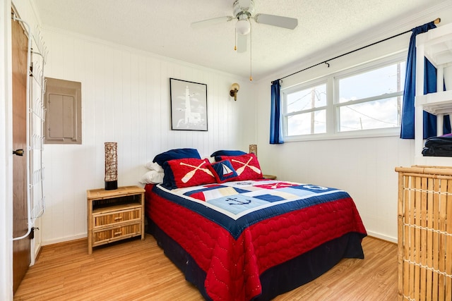 bedroom with hardwood / wood-style floors, ornamental molding, a textured ceiling, and ceiling fan