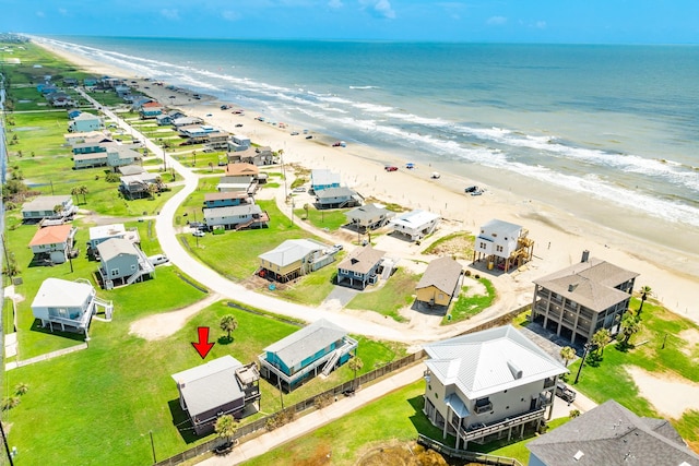 bird's eye view featuring a water view and a beach view