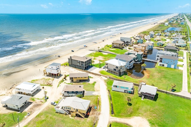 birds eye view of property with a beach view and a water view