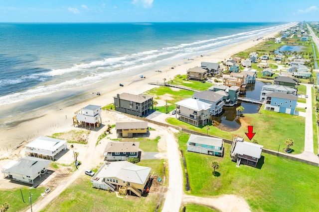 birds eye view of property featuring a beach view and a water view