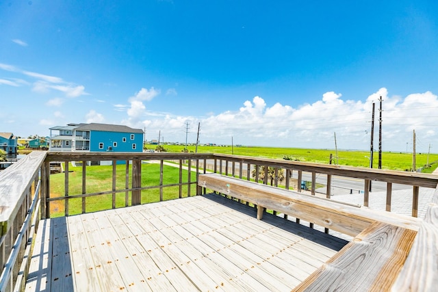 wooden terrace featuring a yard