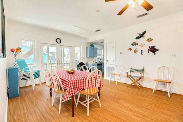 dining room featuring french doors, ceiling fan, and light wood-type flooring