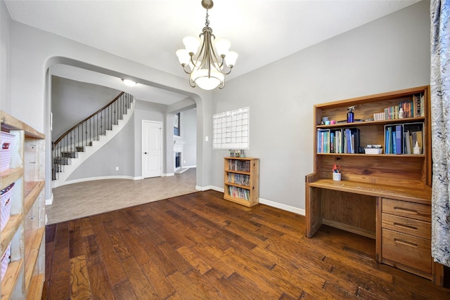 unfurnished office featuring dark hardwood / wood-style flooring and an inviting chandelier