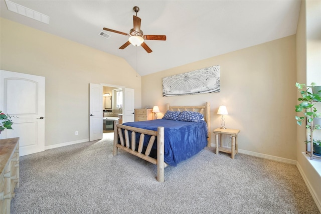 bedroom with ceiling fan, ensuite bathroom, vaulted ceiling, and light carpet