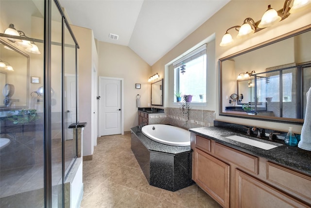 bathroom with vanity, shower with separate bathtub, tile patterned flooring, and vaulted ceiling