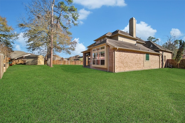 rear view of house featuring a yard