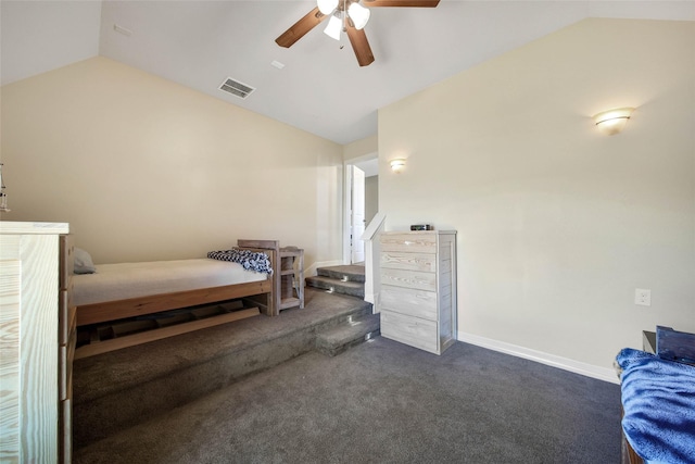 bedroom with dark colored carpet, lofted ceiling, and ceiling fan