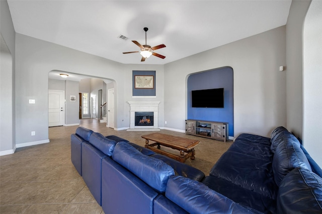 living room featuring ceiling fan and light tile patterned flooring