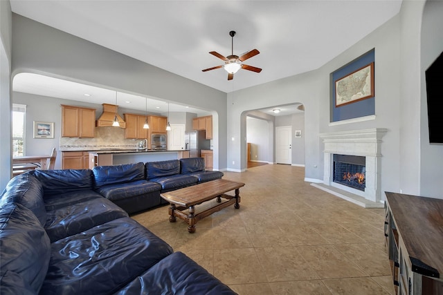 tiled living room with ceiling fan