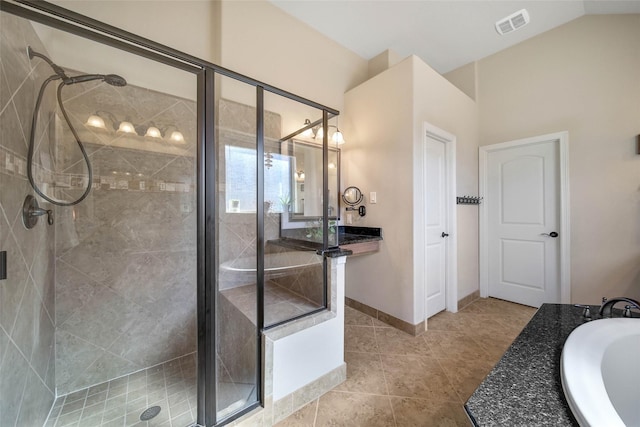 bathroom featuring vanity, tile patterned flooring, vaulted ceiling, and independent shower and bath