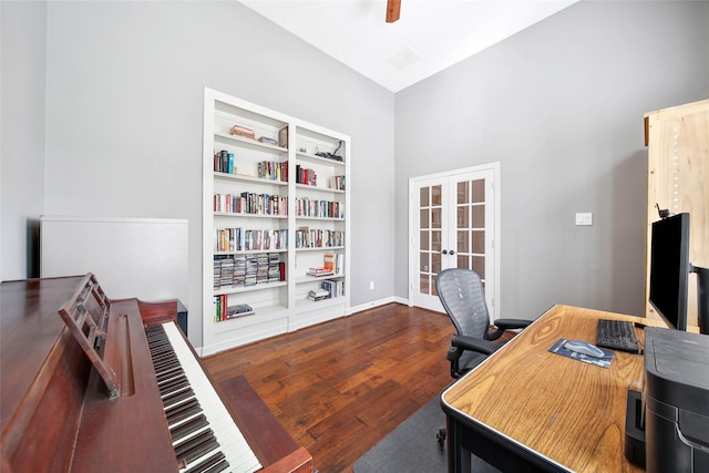 office featuring hardwood / wood-style flooring, vaulted ceiling, french doors, and built in shelves