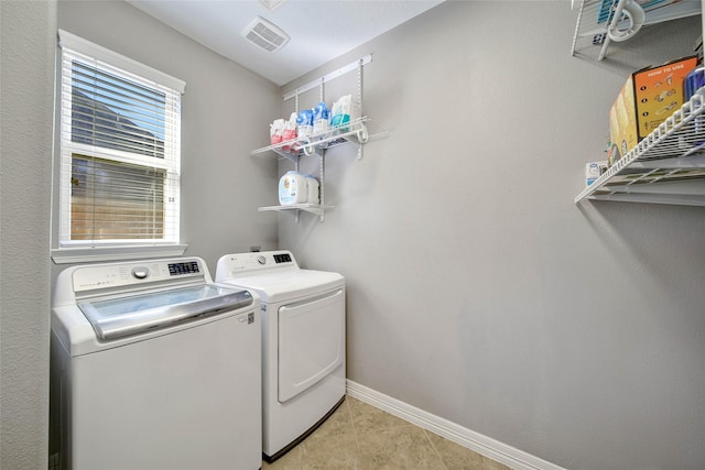 laundry room with light tile patterned floors and independent washer and dryer