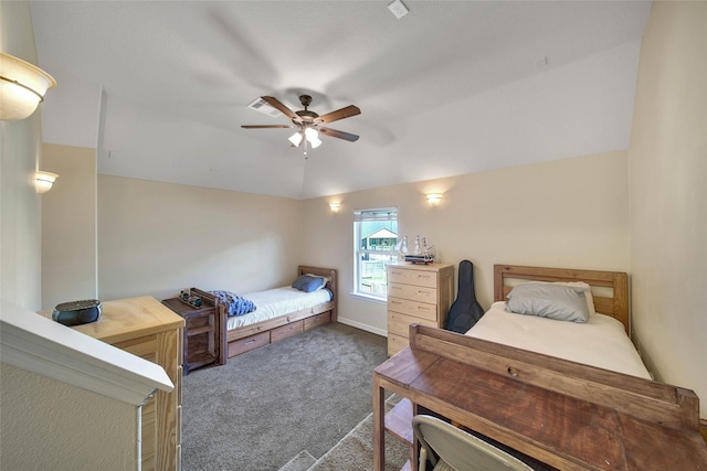 bedroom with vaulted ceiling, ceiling fan, and dark colored carpet