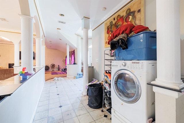 laundry area with crown molding, washer / dryer, light tile patterned flooring, and ornate columns