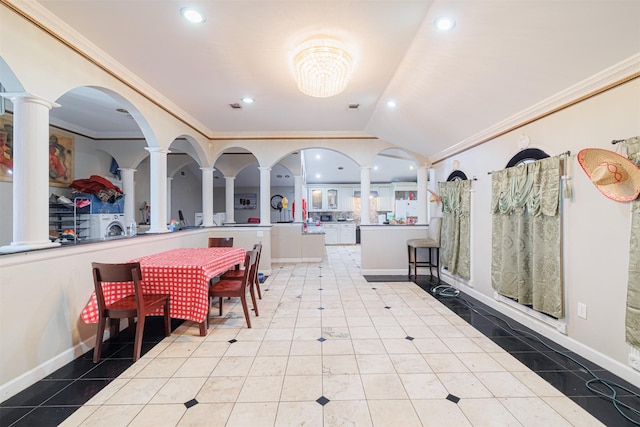 interior space featuring ornate columns, ornamental molding, lofted ceiling, and light tile patterned floors