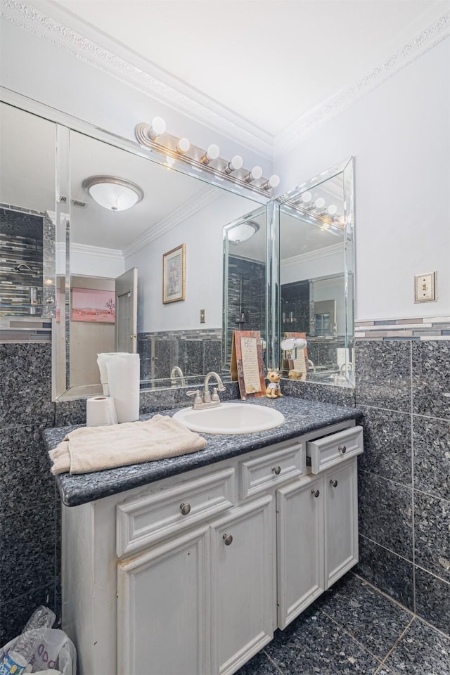 bathroom with tile walls, vanity, and ornamental molding