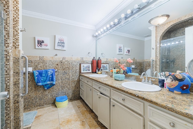 bathroom featuring tile walls, an enclosed shower, crown molding, and vanity