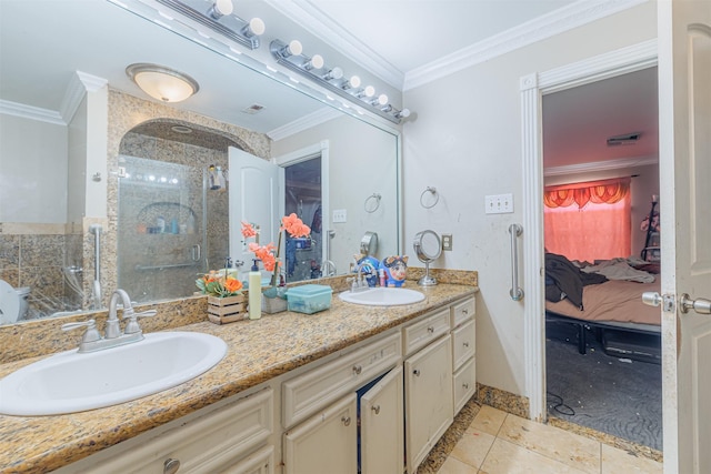 bathroom featuring tile patterned floors, ornamental molding, a shower with door, and vanity