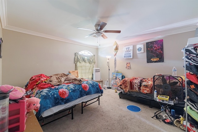 carpeted bedroom featuring crown molding and ceiling fan