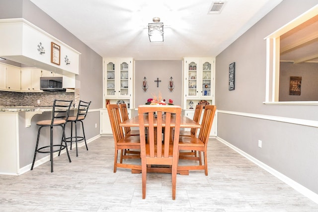 dining space with baseboards and visible vents