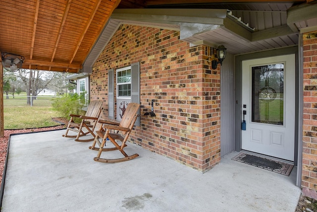 view of exterior entry with brick siding