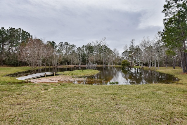 surrounding community with a yard and a water view