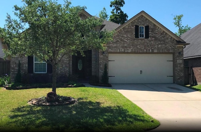 view of front of property with a garage and a front lawn