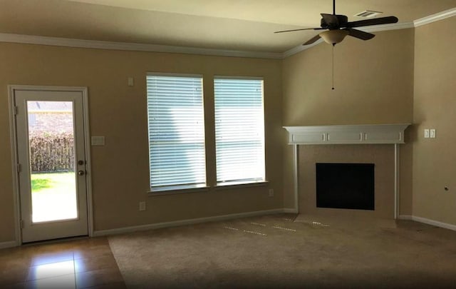 unfurnished living room featuring crown molding, ceiling fan, a fireplace, and tile patterned flooring