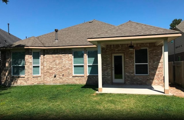 rear view of house with a patio, a yard, and ceiling fan