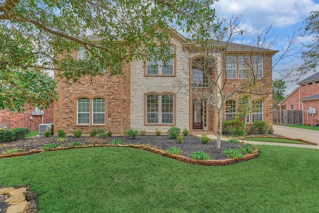 view of front of house featuring a front yard and central AC unit