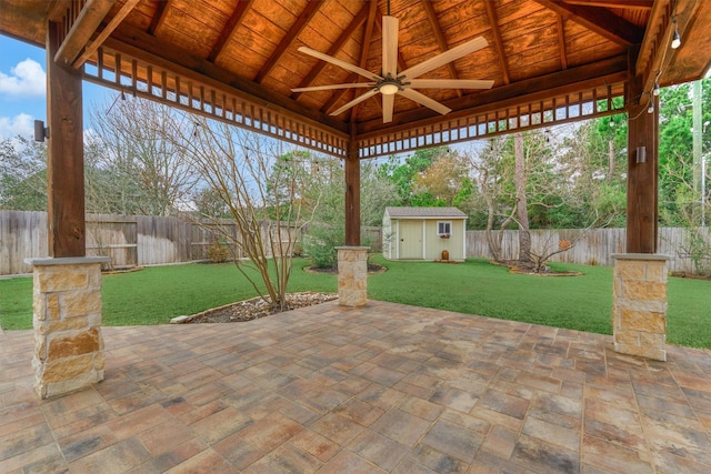 view of patio / terrace with ceiling fan and a storage unit