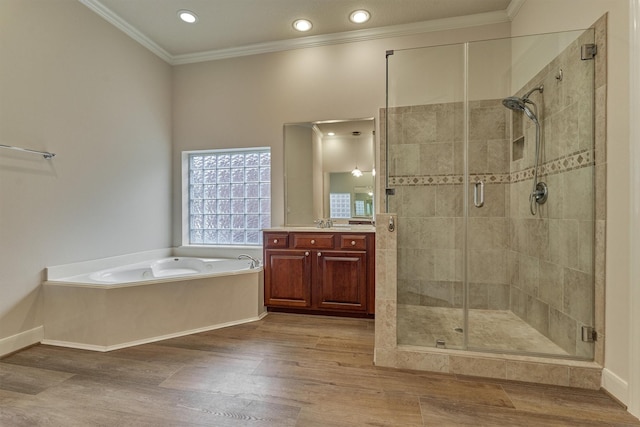 bathroom featuring vanity, crown molding, wood-type flooring, and independent shower and bath