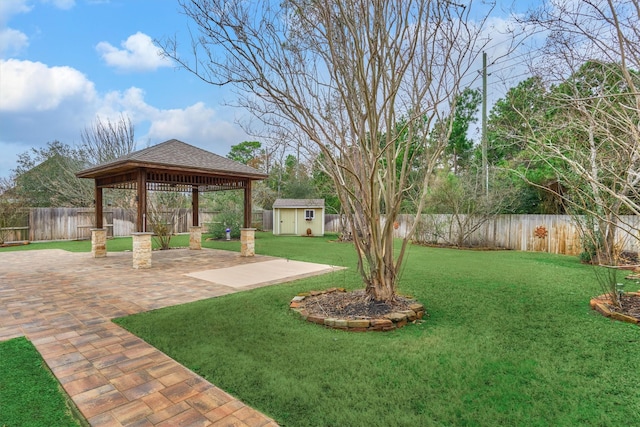 view of yard with a shed, a gazebo, and a patio area