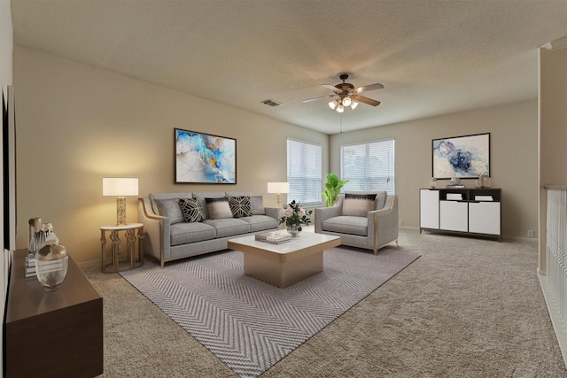 living room with ceiling fan, carpet floors, and a textured ceiling