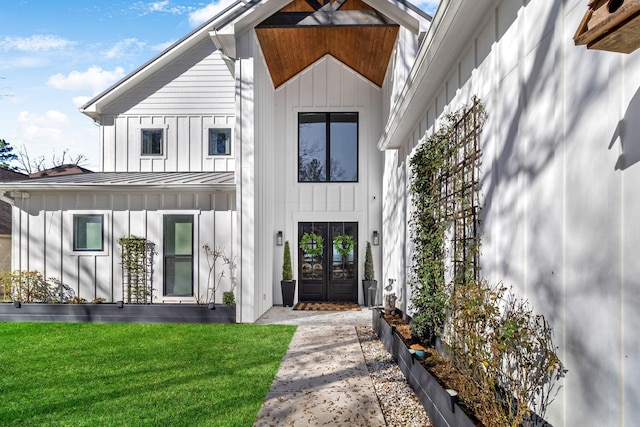 modern farmhouse with a front yard and french doors