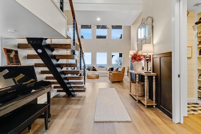 foyer entrance featuring a high ceiling and light wood-type flooring