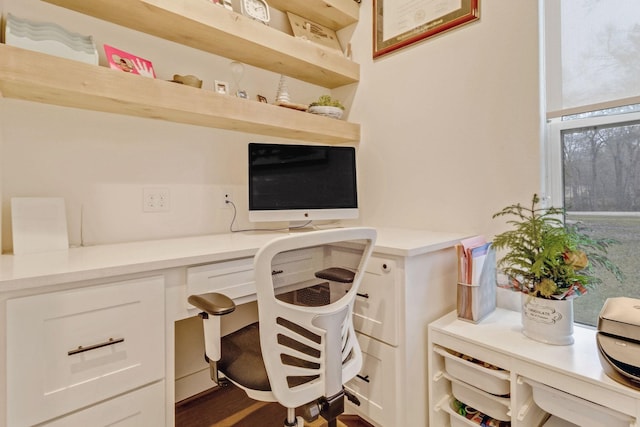 office area featuring dark hardwood / wood-style flooring and built in desk