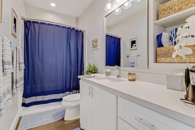 bathroom featuring vanity, toilet, and hardwood / wood-style floors