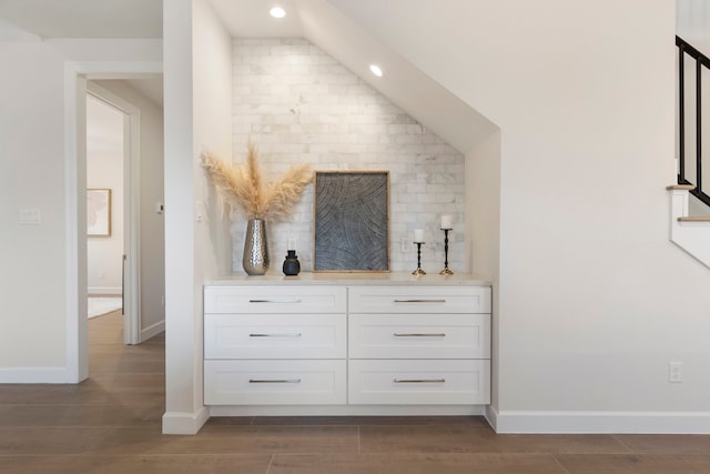 bar featuring white cabinetry, dark hardwood / wood-style flooring, and tasteful backsplash