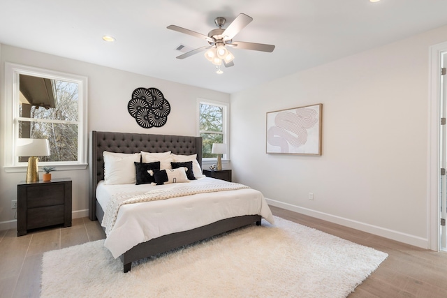 bedroom featuring ceiling fan and light hardwood / wood-style flooring