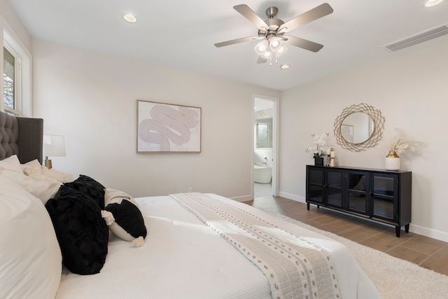 bedroom featuring ensuite bathroom, ceiling fan, and light hardwood / wood-style floors