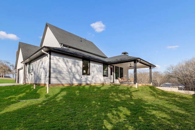 rear view of house with a patio area, ceiling fan, and a lawn