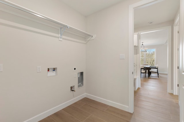 clothes washing area with light hardwood / wood-style floors, a chandelier, hookup for a washing machine, and electric dryer hookup