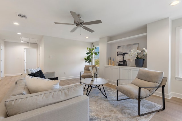 living room with ceiling fan and light wood-type flooring