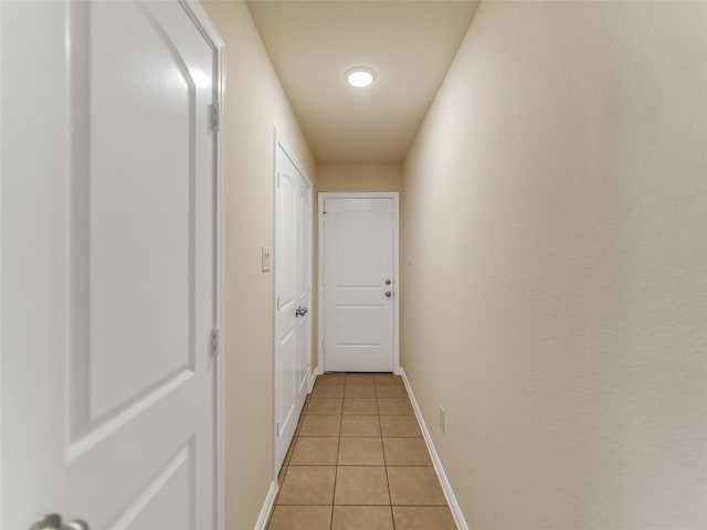 corridor with light tile patterned flooring